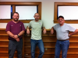 Mike Carl, Jason Carl and Larry Carl. Larry built the shelves dedicated in memory of RoBerta Thomas.